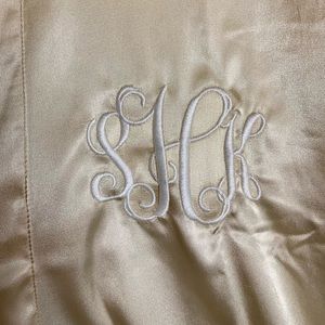 Silky gold robe. With “sKh” monogram. Never worn.